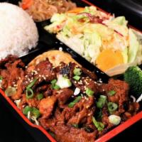 Chili Pork Box · Spicy pork loin filet, served with rice, salad, jabchae, and a potsticker.