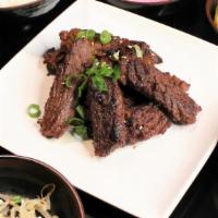 Sesame Beef Dinner · Diamond cut beef with a sesame garlic marinade, served with rice and Korean side dishes.