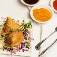 Samosas · Two crispy stuffed pastries seasoned with mild spices and deep fried.