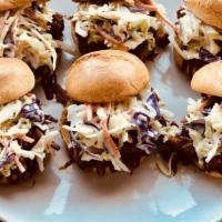 Bbq Pulled Pork Sliders · Slowly cooked BBQ pulled pork on a bed of coleslaw. Topped off with BBQ sauce drizzles on a ...
