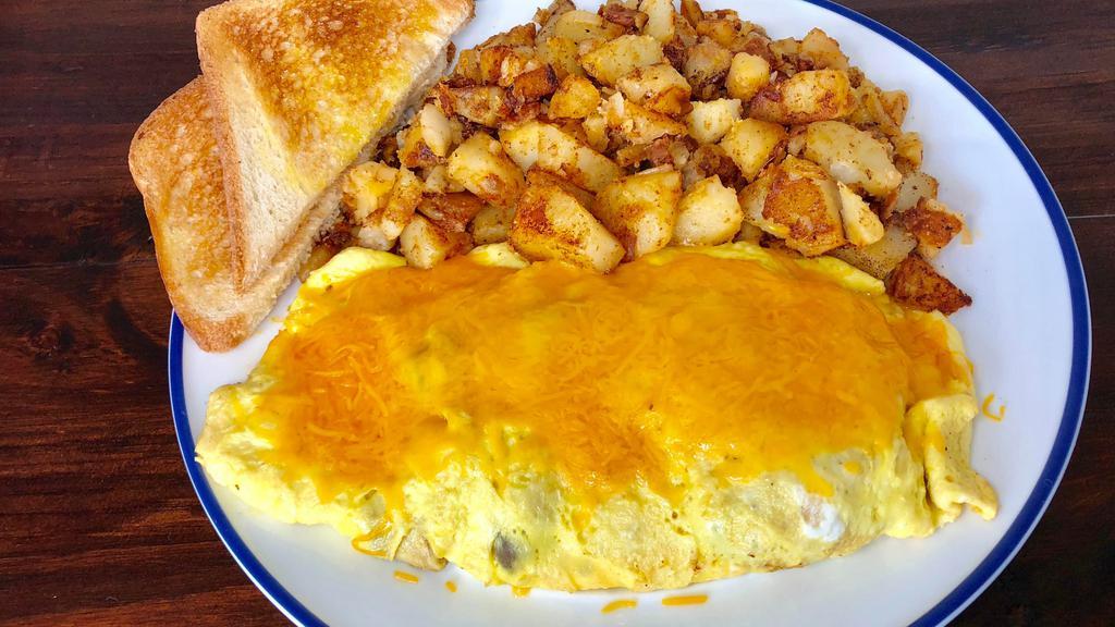 Veggie Omelette · Three eggs omelette filled with mushrooms, tomato, onion, bell pepper, and your choice of cheese. Served with breakfast potatoes and a toast.