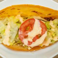 9 Tacos / Tacos · Dos tortillas duras de maíz con tu elección de pollo, carne o cerdo. / Two hard shell corn t...