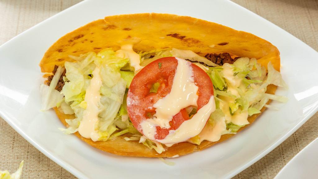 9 Tacos / Tacos · Dos tortillas duras de maíz con tu elección de pollo, carne o cerdo. / Two hard shell corn tacos, chicken, beef or pork.