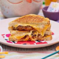 Super Cheesy · cheddar, swiss, and havarti cheese, grilled onions, tomato between two slices of buttery gri...