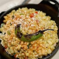 Esquite De Elote · Roasted corn, bell peppers, onions, serrano, crema and queso Cotija.