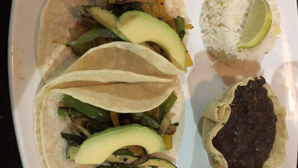 Tacos De Mahi Mahi · Two Mahi Mahi tacos, cabbage, pico de gallo, avocado, chipotle sauce, served with white rice and black beans.