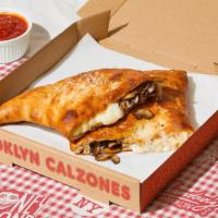 Rockaway Calzone · Calzone with mushroom, melted mozzarella, and a side of marinara.