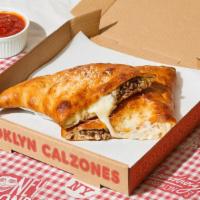 Bushwick Calzone · Calzone with ground beef, tomato sauce, creamy ricotta, melted mozzarella, and a side of mar...