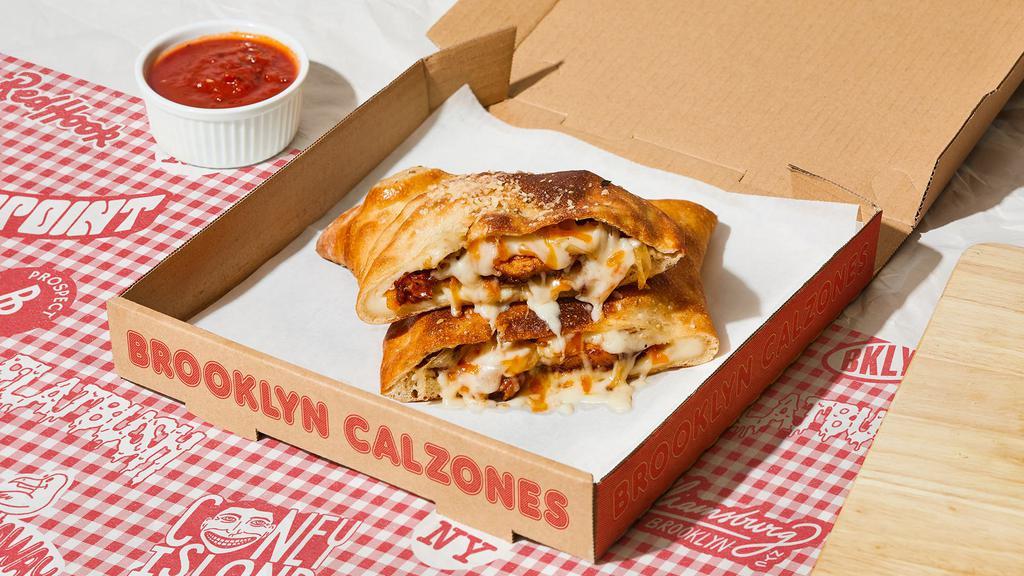 Flatbush Calzone · Calzone with juicy BBQ chicken, onion, melted mozzarella, and a side of marinara.