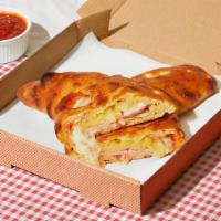 Brooklyn Bridge Calzone · Calzone with savory turkey bacon, pineapple, melted mozzarella, and a side of marinara.
