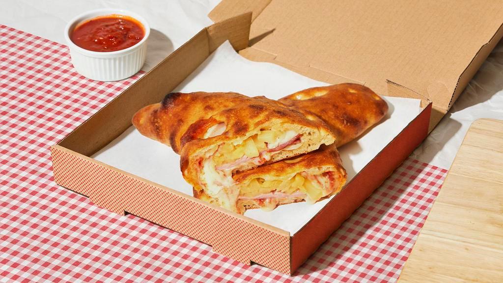 Brooklyn Bridge Calzone · Calzone with savory turkey bacon, pineapple, melted mozzarella, and a side of marinara.