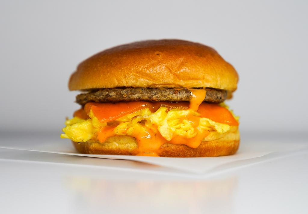 Brioche, Sausage, Egg, & Cheddar Sandwich · 2 scrambled eggs, melted Cheddar cheese, breakfast sausage, and Sriracha aioli on a warm brioche bun.