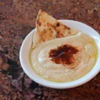 Hummus · Chickpeas and tahini dip drizzled with olive oil and paprika - served with naan