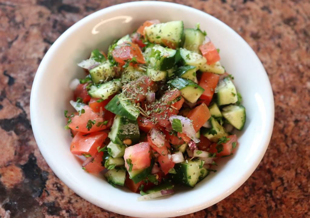 Shirazi Salad · Chopped tomatoes, cucumbers, and onions dressed with red wine vinegar and olive oil