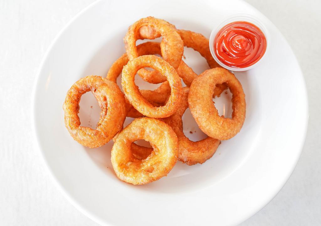 Onion Rings · 8 onion rings lightly covered in beer batter and deep fried to a crisp, served with a side of ranch.