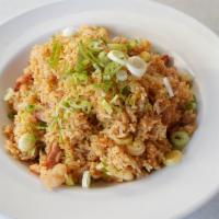 Crab Shack Garlic Fried Rice · Cajun seasoned fried rice, tossed with shrimp and pork sausage and topped off with chopped g...
