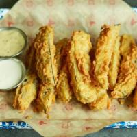 Southern Fried Dill Pickles · Served with Creole mustard dipping sauce and ranch dressing.