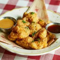 Hot-Honey Cauliflower Bites · Cauliflower florets tossed in our signature. seasoned breading and lightly fried, then sprin...