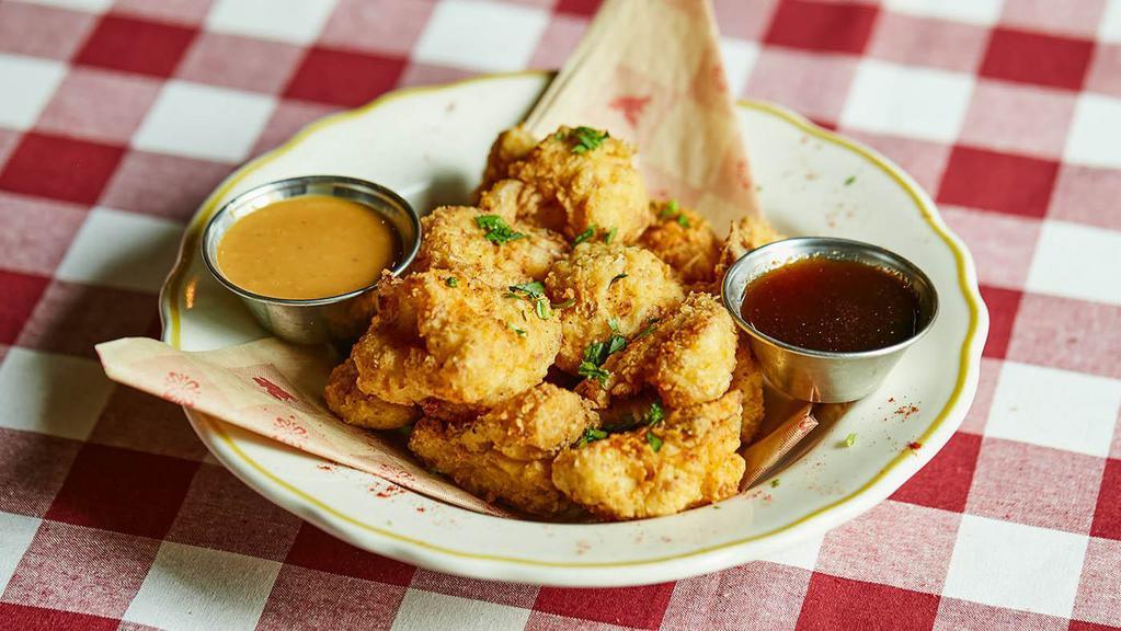 Hot-Honey Cauliflower Bites · Cauliflower florets tossed in our signature. seasoned breading and lightly fried, then sprinkled with our special seasoning to deliver a crispy crunch. Served with signature BBQ ranch and a smokin’ hot-honey infusion.