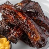 Bbq Beef Ribs · Tender, big and meaty beef ribs, spice-rubbed, slowly smoked, then glazed with our BBQ sauce.