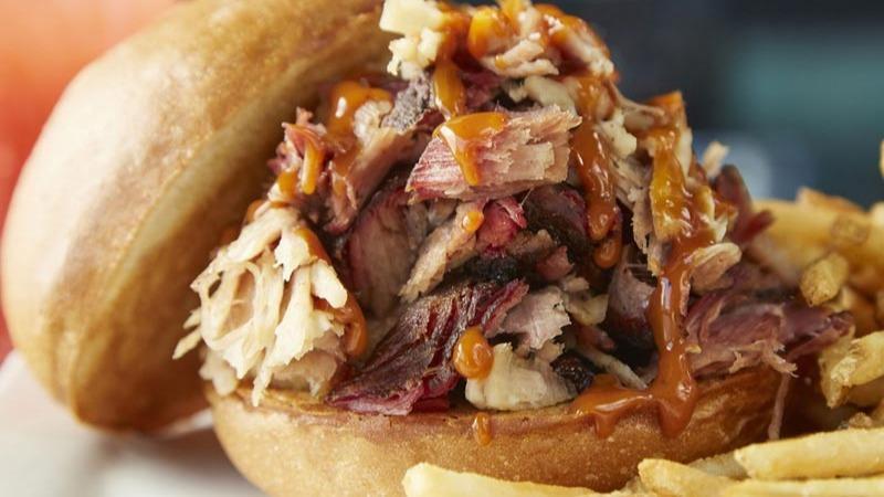 Lucille'S Original Pulled Pork Sandwich · Our special pork roast, slow-smoked until it's fork-tender, hand shredded and tossed in our special sauce on a potato bun.