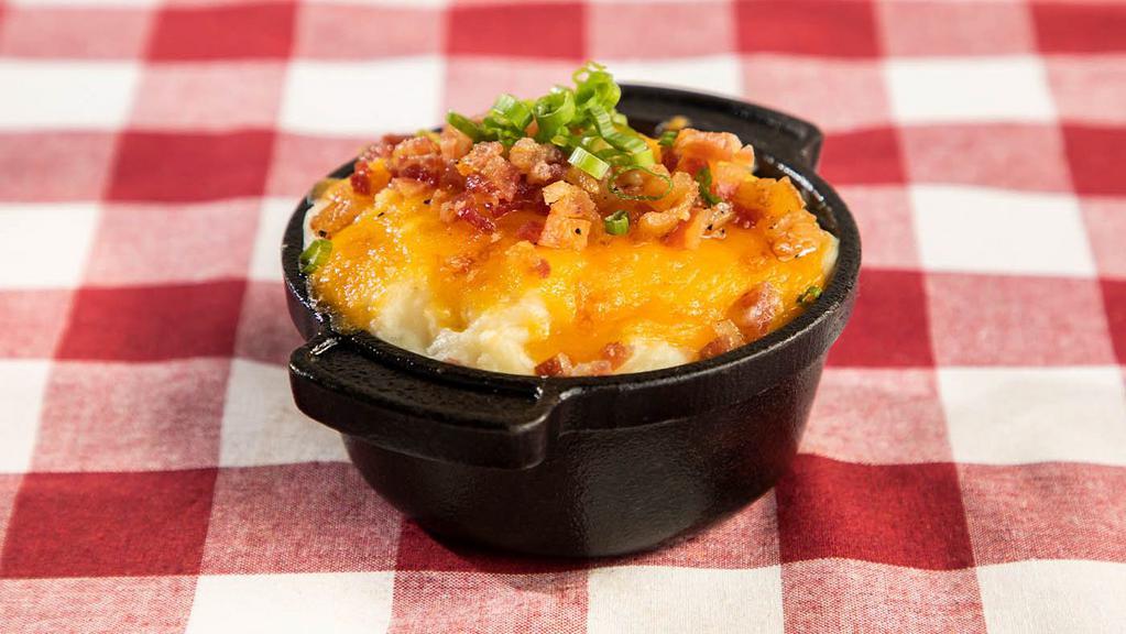 Loaded Mashed Potatoes · Lucille’s own garlic mashed potatoes topped with butter, sour cream, cheddar cheese, chopped bacon and green onions.