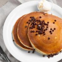Chocolate Chip Pancakes · Our famous pancakes with semi-sweet chocolate chips melted inside! Topped with chocolate chi...
