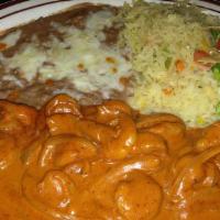 Camarones En Crema De Chipotle · Shrimp in spicy red sauce. Served with Mexican rice, refried beans and a side salad.