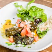Dolmathes · Cooked grape leaves filled with rice, tarragon, split peas, green onions, basil, parsley and...