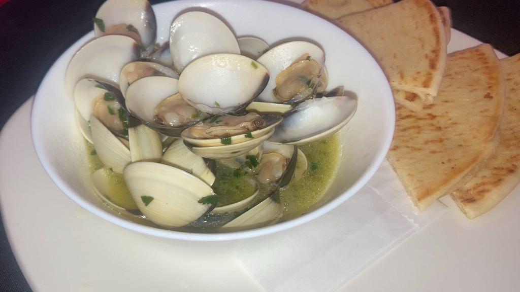 Steamed Clams · Clams Steamed in white wine butter garlic sauce. Comes with Pita Bread