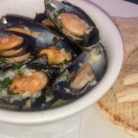 Steamed Mussels  · Mussels steamed in white wine butter garlic sauce. Comes with Pita Bread