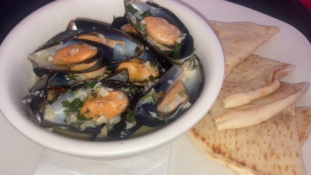 Steamed Mussels  · Mussels steamed in white wine butter garlic sauce. Comes with Pita Bread