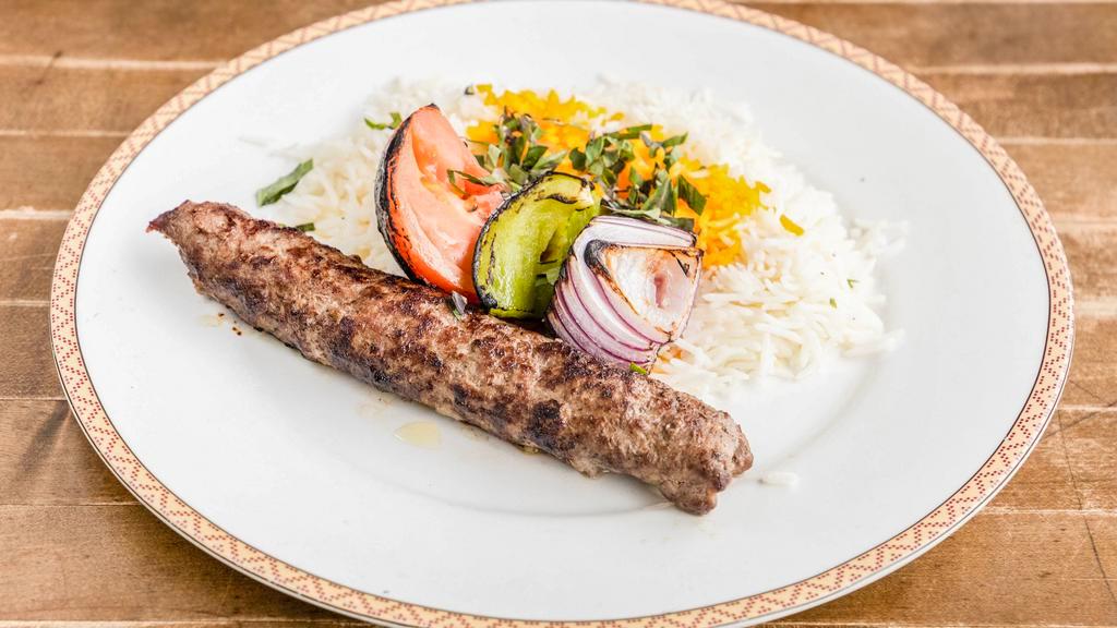 Koobideh Kabob · Juicy, charbroiled seasoned ground beef served with a charbroiled tomato and basmati rice topped with saffron.