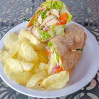 Chicken Caesar Wrap · With red onions, tomatoes, Parmesan cheese, romaine lettuce, and creamy Caesar dressing.