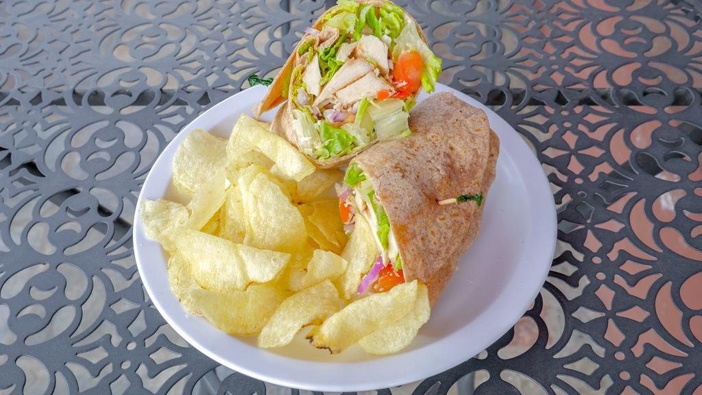 Chicken Caesar Wrap · With red onions, tomatoes, Parmesan cheese, romaine lettuce, and creamy Caesar dressing.