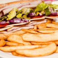 Turkey Breast Sandwich · Served with steak fries. Mayo, mustard, lettuce, tomatoes, red onions, and Provolone cheese.