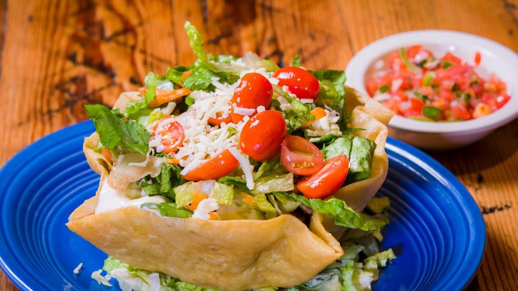 Taco Salad · Your choice of meat or vegetarian plus beans, rice, salsa, cheese, guacamole, sour cream and lettuce.