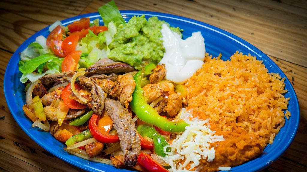 Fajitas Pollo O Res · Chicken or beef fajitas. Includes rice, beans, sour cream, guacamole, lettuce, tomatoes and tortillas.
