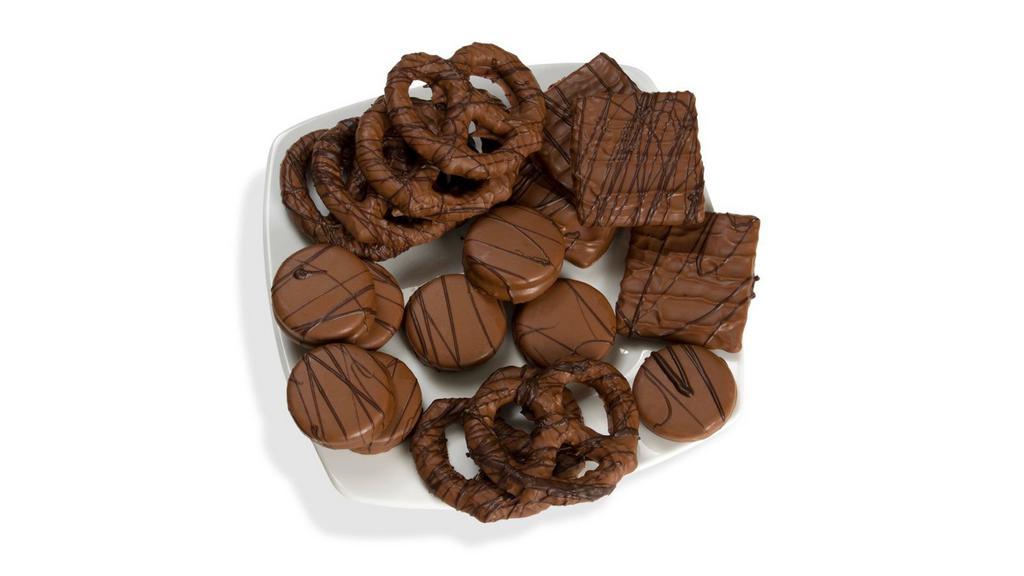 Scrumptious Snacks Assortment · 1lb. Assortment of decadent groumet snacks for sharing.  Bavarian pretzels, oreos® and graham crackers in rich milk chocolate decorated with dark chocolate strings.