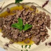Brown Hummus · Vegetarian. Hummus topped with sautéed meat, onions, and pine nuts. Beef or lamb.