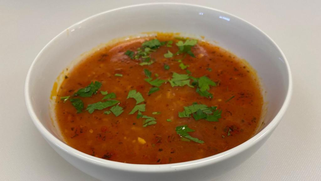 Tomato Soup · Vegetarian. Fresh ripe tomatoes cooked with rice & spices, topped with mint & garlic.