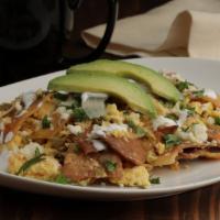 Chilaquiles · Fried Corn Tortillas Cooked w/ Scrambled Eggs in Mild House Salsa, Onion, Cilantro, Sliced A...