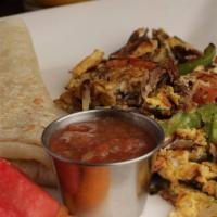 Machaca · Roasted shredded beef chunks cooked w/ sliced onions, bell peppers, tomatoes, eggs. Comes wi...