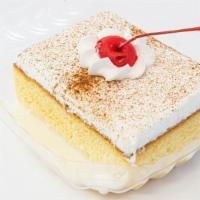 Tres Leches · A dense, moist “three milks” cake topped with a cloud of vanilla whipped cream.