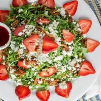 Strawberry Arugula Salad · Vegetarian. Wild arugula with sliced strawberries, goat cheese, and candied pecans tossed in...