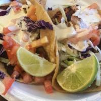 Fish Tacos · Cabbage, White Sauce, Fresca & Salsa Verde.
