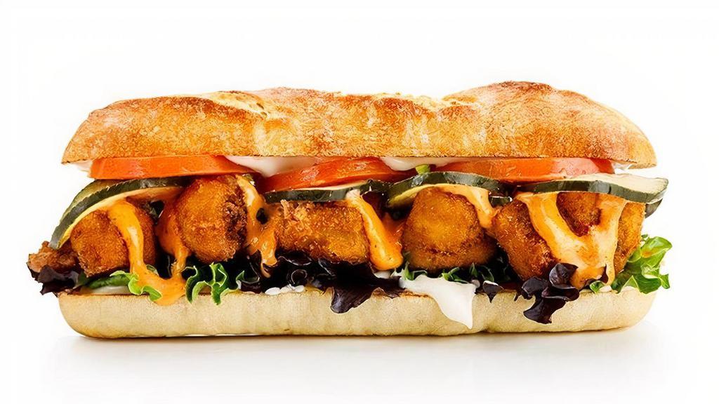 Cauliflower Po' Boy · Cajun-seasoned fried cauliflower, pickle chips, tomatoes, lettuce, creamy Cajun sauce, toasted French baguette, side of your choice