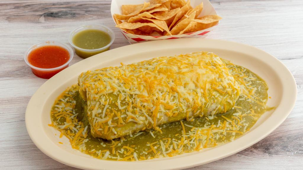 Wet Burrito · With your choice of of meat, (steak, chicken, carnitas, al pastor,) red or green sauce on top, cheese, rice, beans, guacamole, sour cream and pico de gallo in a flour tortilla), with chips, salsa and guacamole.