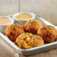 New Fried Couscous Mac & Cheese Balls · Pearl couscous | jack + cheddar cheese sauce | applewood smoked bacon | tomatoes | green oni...