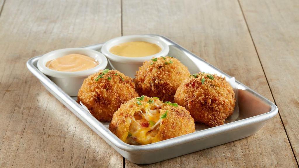 New Fried Couscous Mac & Cheese Balls · Pearl couscous | jack + cheddar cheese sauce | applewood smoked bacon | tomatoes | green onions | basil | coated in panko bread crumbs | sriracha aioli and housemade sriracha queso  for dipping